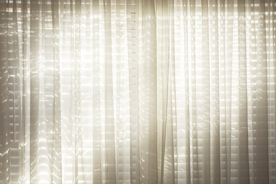 curtains, blinds, window, light, sheer, fabric, home interior background with soft morning sunlight filtering through venetian slats and white drapes creating a cozy atmosphere.