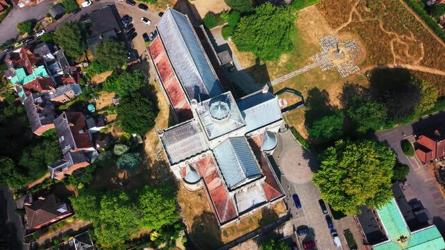 Top-down drone shot of Romsey Abbey's cruciform roof, central tower and surrounding memorial garden.