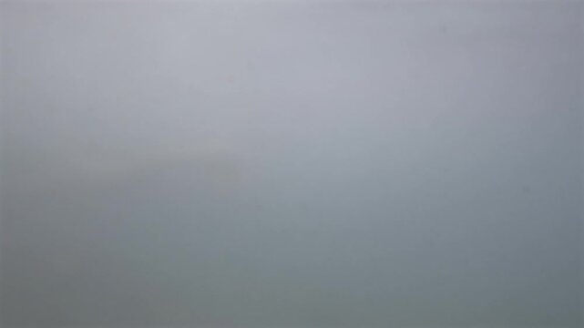 Abstract gray gradient background creating a minimalist, textured backdrop. Displaying smooth color transition and a soft, foggy feel