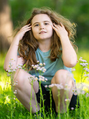 Fototapeta premium Summer nature supports outdoor recreation. Warm summer sunlight brightens smiling face. Summer park creates cheerful background. Summer childhood feels joyful and relaxed.