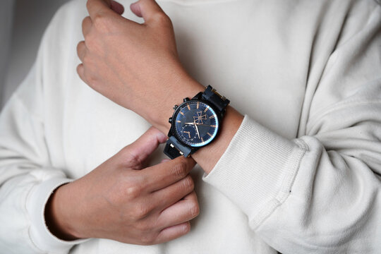 Stylish Black Wristwatch on Man Wrist Wearing White Casual Outfit, Modern Men Fashion Lifestyle