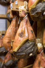 Storage of prosciutto in a ham factory in Bologna, Italy © Maria