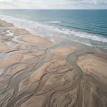 Aerial Drone View of Coastal Sand Bank with Natural Water Channels and Wavy Ocean Tide