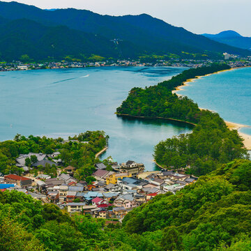 Panoramic high-angle view of the iconic pine-covered sandbar and surrounding bay at Amanohashidate in Kyoto Prefecture, Japan.