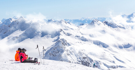 Fototapeta premium Two girls sitting high up in the mountains