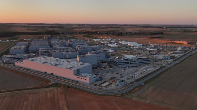 Aerial drone view of Umicore battery materials production plant in Radzikowice near Nysa, Poland, surrounded by agricultural fields. Factory producing cathode materials for lithium ion batteries