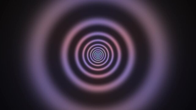 This visual features a spiral design with concentric circles filled with blue and purple hues. The pattern creates a sense of depth and movement in a dark background