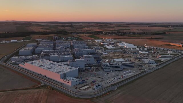 Aerial drone view of Umicore battery materials production plant in Radzikowice near Nysa, Poland, surrounded by agricultural fields. Factory producing cathode materials for lithium ion batteries