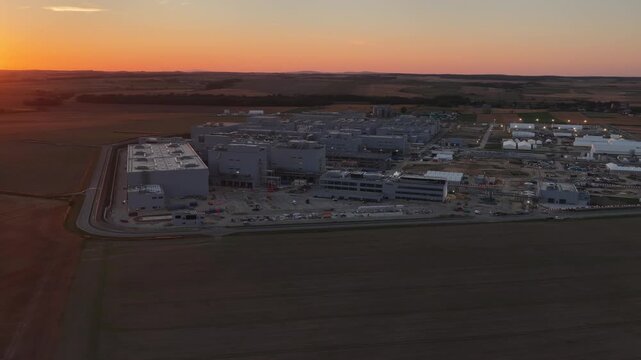 Aerial drone view of Umicore battery materials production plant in Radzikowice near Nysa, Poland, surrounded by agricultural fields. Factory producing cathode materials for lithium ion batteries