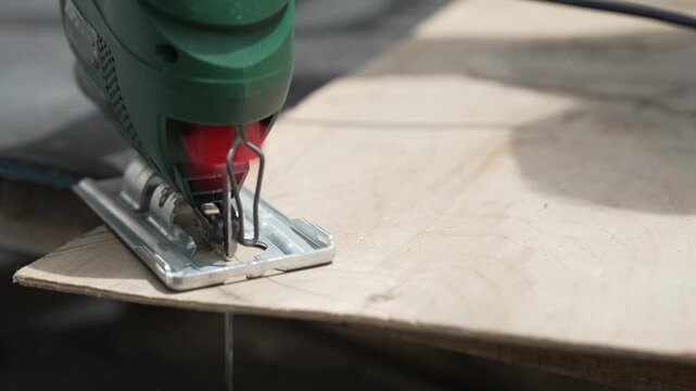 DIY Furniture Restoration: Woman Using an Electric Jigsaw to Give an Old Chair a Second Life