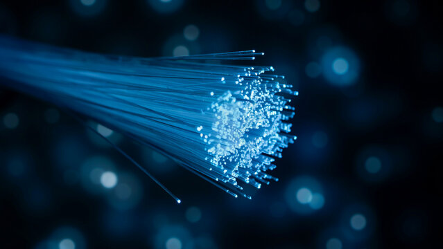 Glowing blue fiber optic cables transmitting data signals through dark space with bright bokeh light spots