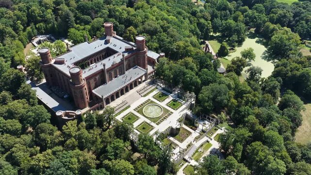 Aerial drone view of the historic Kamieniec Zabkowicki Palace in Lower Silesia, Poland, featuring monumental architecture, landscaped gardens and historic surroundings