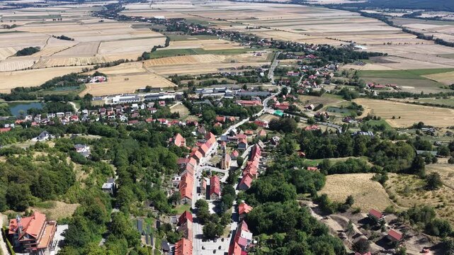 Aerial drone view of Srebrna Gora village in Lower Silesia, Poland, with historic Srebrna Gora Fortress, surrounding mountains and green landscape on a sunny summer day