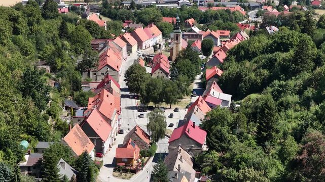 Aerial drone view of Srebrna Gora village in Lower Silesia, Poland, with historic Srebrna Gora Fortress, surrounding mountains and green landscape on a sunny summer day