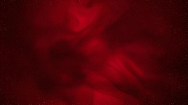 Abstract red smoke or ink swirling in dark background with glowing effect and mystical atmosphere