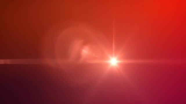 Bright red light flare with glowing sunburst effect on dark background for abstract design