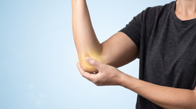Man holding painful elbow joint with glowing effect, concept of arthritis or injury pain relief treatment, medical healthcare background for therapy and rehabilitation services.