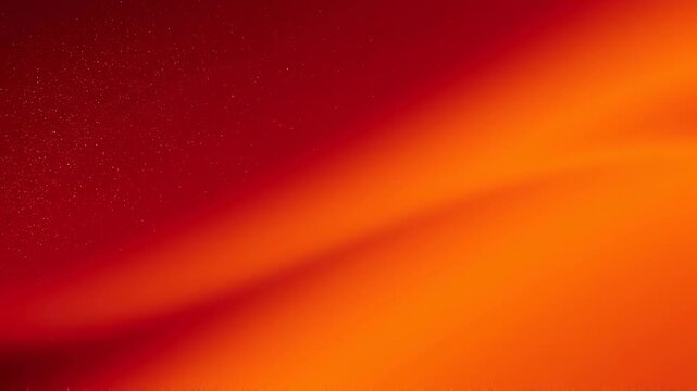 Abstract red and orange gradient background with smooth vibrant colors and subtle sparkling texture