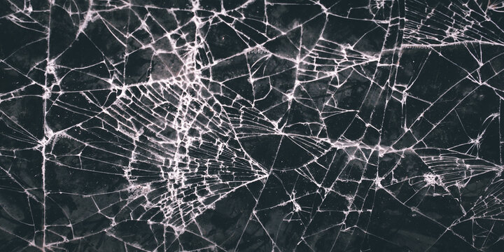 texture and background of broken glass with intricate patterns. damage to the glass
