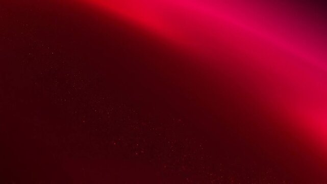 Red and pink gradient background with sparkling particles for vibrant abstract digital design