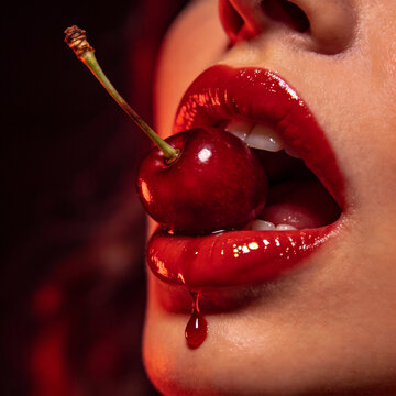 Vibrant Close-up of Glossy Red Lips Holding a Juicy Cherry, with a Syrupy Drop of Juice Dripping Down