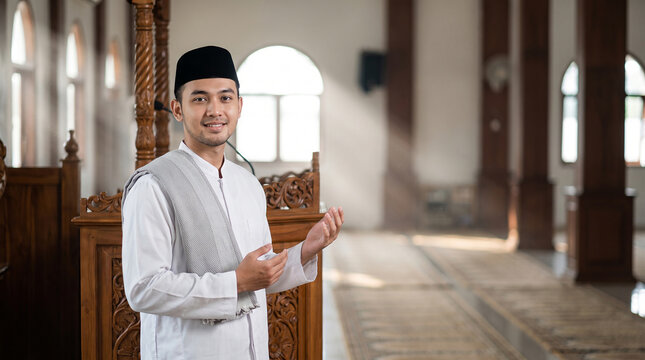 Portrait of a Smiling Young Imam Wearing White Robe and Grey Scarf Standing Gracefully Beside a Mosque Pulpit