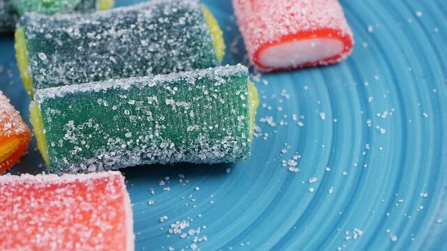 Colorful candy on a blue plate with sugar sprinkles