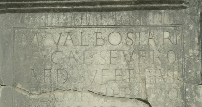 Close-up of the Marcus Valerius Severus inscription at Volubilis, a key Latin record of privileges obtained for the city under Emperor Claudius at Morocco's UNESCO site.