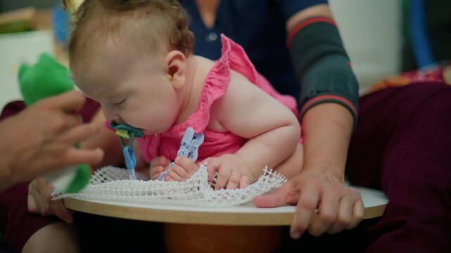 Infants engaging in physical therapy sessions, stimulating early development and improving motor skills with professional assistance