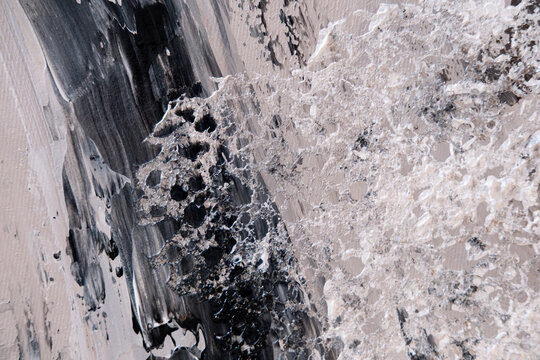 Painting canvas. Ink strokes. Creative background with black beige gray color abstraction mixing on modern art texture.