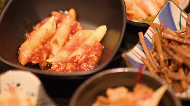 Assorted Japanese Izakaya Side Dishes and Appetizers in Ceramic Bowls