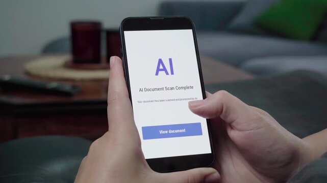 Hands hold a smartphone displaying an AI Document Scan Complete message with a blue View document button in a casual living room.