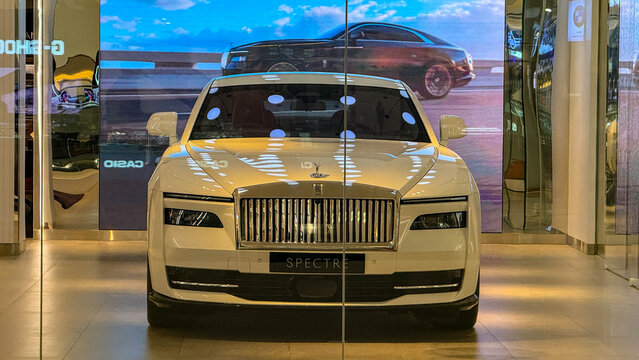 BANGKOK, THAILAND - JULY 16, 2026: Luxury Rolls-Royce Spectre electric car displayed inside the official showroom at Siam Paragon shopping mall.