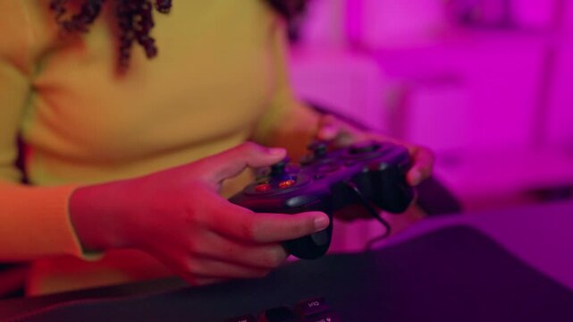 Close up of a teenage girl playing online video game on computer. 