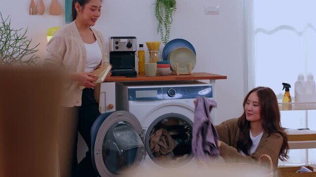 Laundry room woman washing machine clothing towel basket detergent home cleaning chore household fabric care supplies clean domestic appliance loading washer basket shelf plant helper nearby
