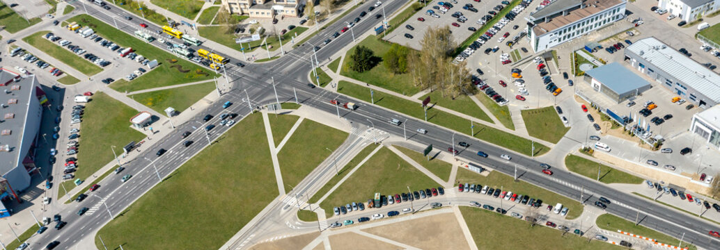 crossroad in the city. streets intersection with cars traffic. panoramic aerial view at sunny summer day.