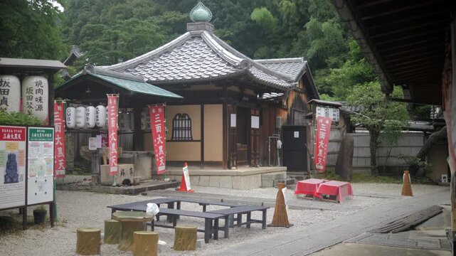 Traditional Japanese temple courtyard with benches and lanterns in Kyoto, Japan