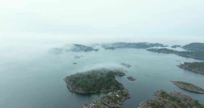 Aerial view of misty fjord islands in H&oslash;llen Norway showing rocky islands