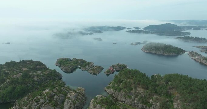 Aerial view of forested islands in Norwegian fjord waters showing quiet