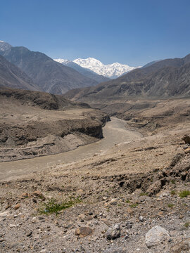 Vertical desert mountain landscape view of Indus river valley and mighty snowcapped Nanga Parbat, Thalich bridge, Astore, Gilgit Baltistan, Pakistan
