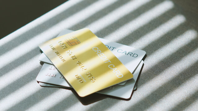 Smart spending options, Stacked of multiple credit cards on desk under soft window blind light. business credit concept.