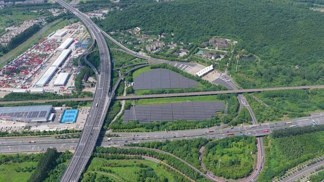 Aerial view of solar panels and a highway interchange