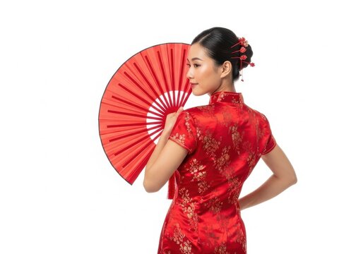 Woman holding red fan in traditional dress with flowers in hair
