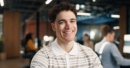 Obraz premium Happy, professional and portrait of businessman in office with confidence for career in web development. Smile, about us and software developer with pride for UX design project in startup workplace.
