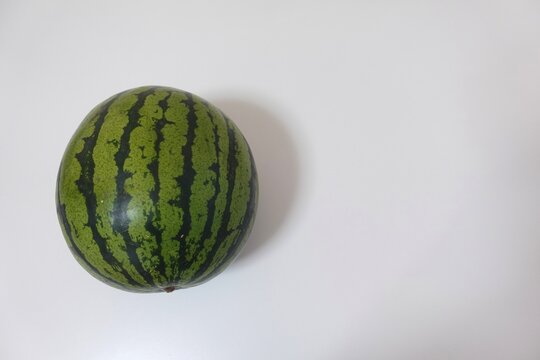 Whole watermelon photo with wide white copy space for summer foo