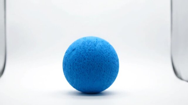 Levitating Blue Textured Bath Bomb on White Studio Background