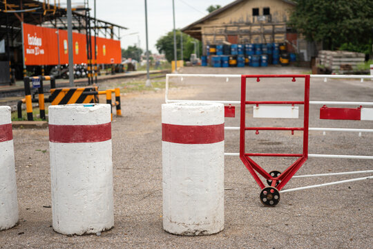 Heavy duty cement traffic barriers and security fencing installation at an industrial warehouse entrance.