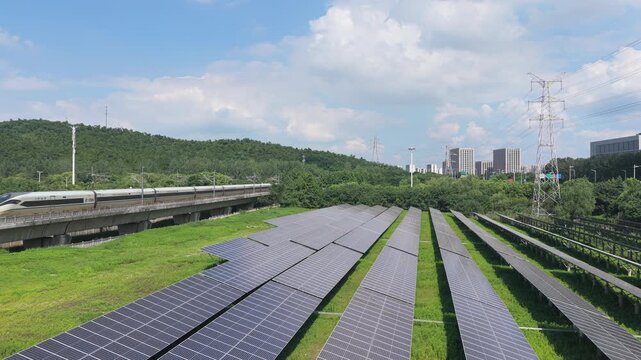 Drone flying forward over solar panels toward a city skyline