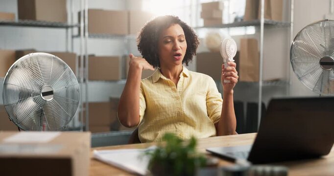 Heat, fan and woman with laptop in warehouse for distribution, logistics and ventilation problem. Small business, tech and air flow appliance for HVAC issue, hot and hyperhidrosis or supplier stress