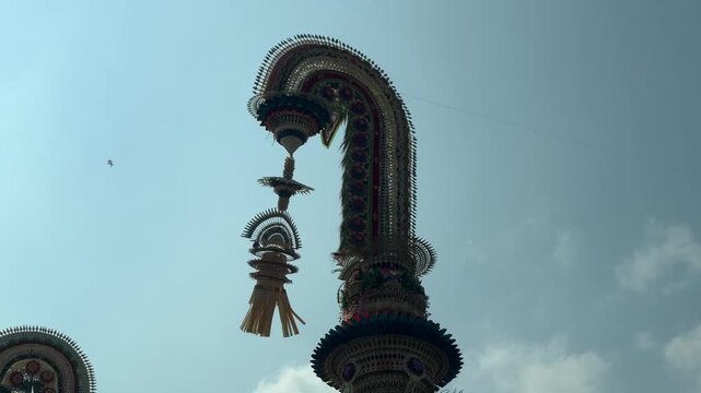Traditional Balinese Penjor decoration against the blue sky during Galungan and Kuningan celebrations, symbolizing prosperity, gratitude, and spiritual devotion in Balinese Hindu culture.